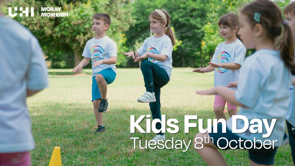 An image of children doing warm up physical activity outside on the grass. Overlaid is the text 