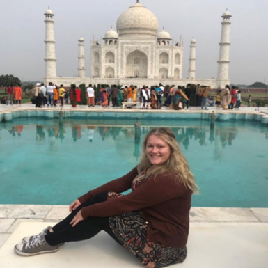 Photograph of Kristy Jones, Co-Ordinator of the ESF Employability programme, sitting in front of the Taj Mahal in India