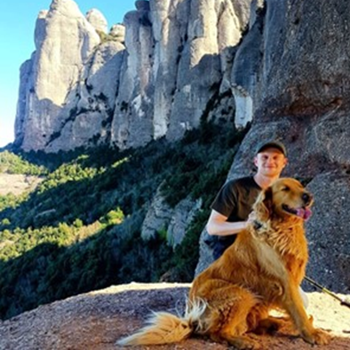 Photograph of Marc Luxon, Employability Support Worker, with his dog in the outdoors on a hike