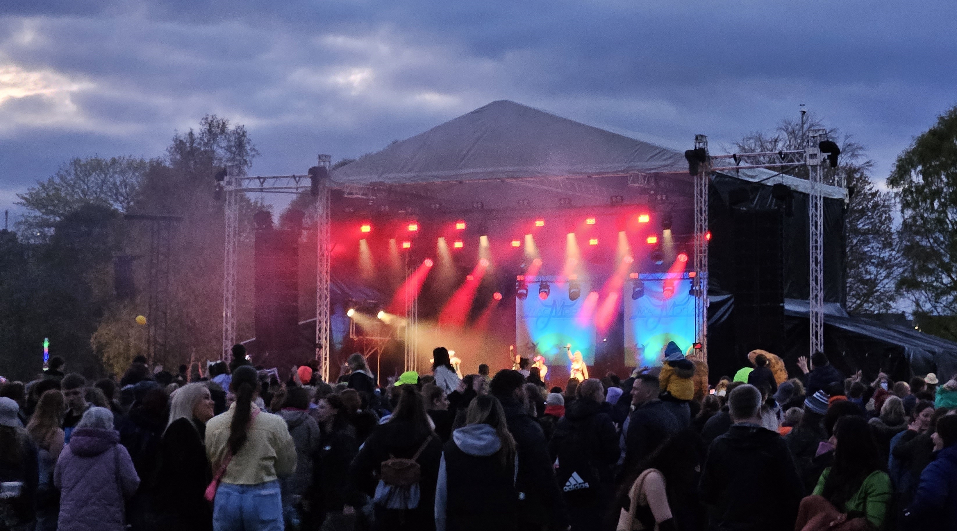 Photograph of the main stage at MacMoray 2023 with a lively crowd Photograph of the main stage at MacMoray 2023 with a lively crowd